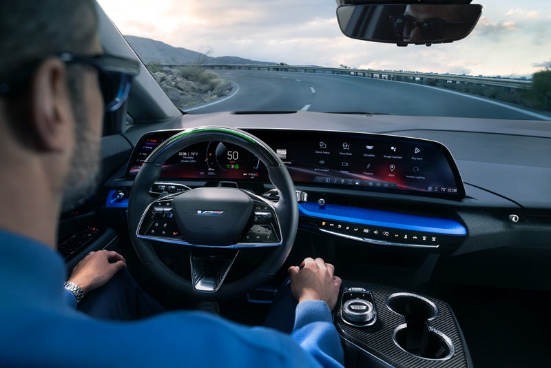 Front View of the 2026 OPTIQ-V Driving Through the Dusk Utilizing its Headlights | Marvin K. Brown Cadillac in San Diego CA